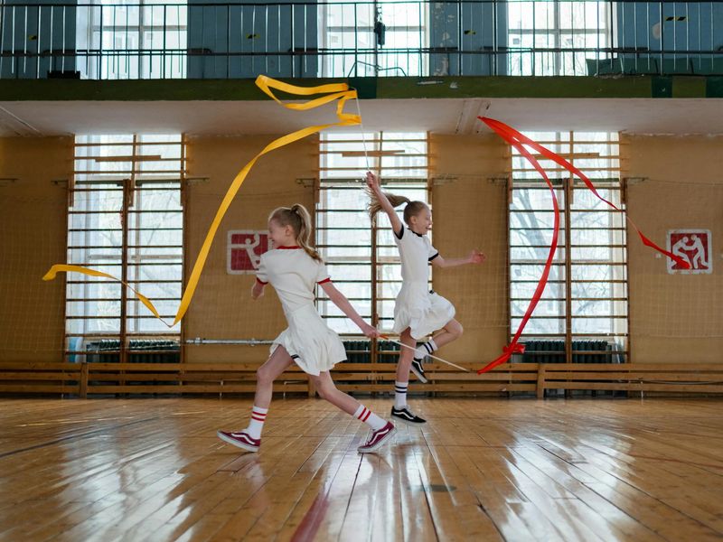 Person performing rhythmic cardio exercises in a bright studio